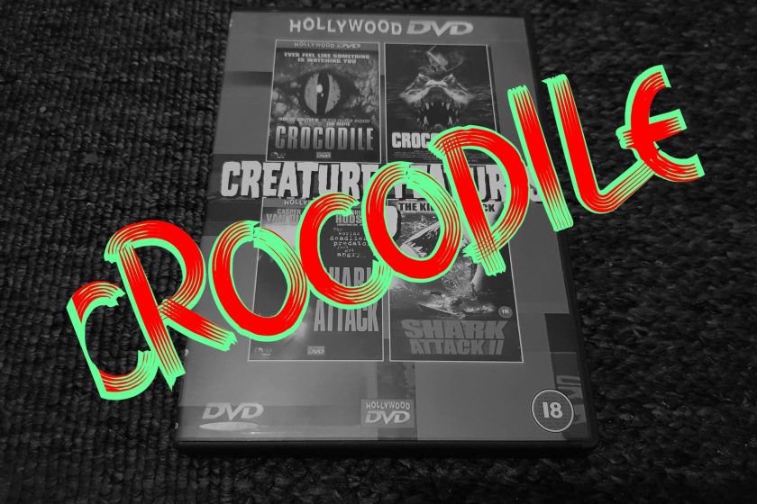 A black and white image of a DVD case with the word "CROCODILE" in green and red writing stamped across it