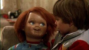 A still from the movie Childs Play, showing the Chucky doll and child